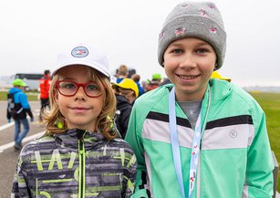 Two girls laugh at the camera.