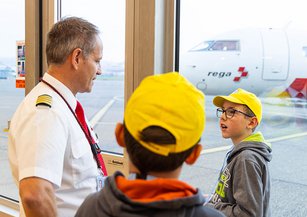 A boy talks to a jet pilot.