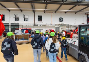 A group of children run through the Rega hangar.