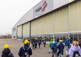 A group of children run towards the Rega Centre.