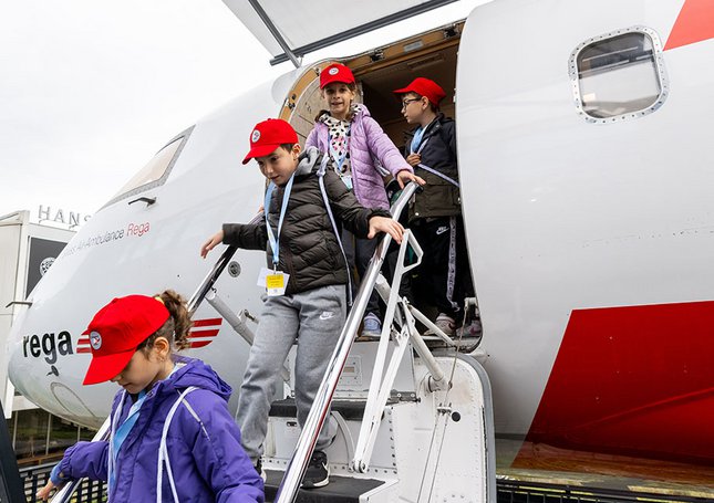 Kinder verlassen den Rega-Jet über die Treppe