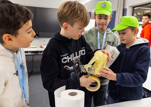 A group of boys are doing crafts.