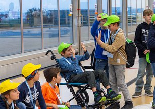 Two boys high-five each other.